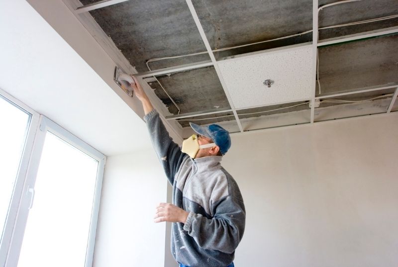 Plasterer Newcastle repairing a plasterboard false ceiling